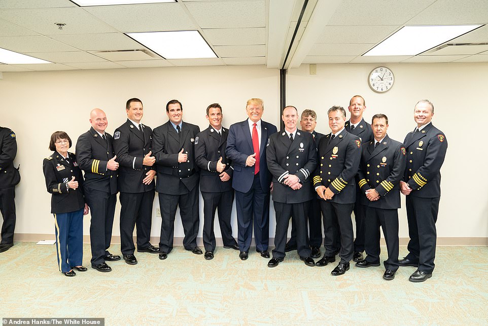 17018242-7332199-First_response_The_president_posed_for_pictures_with_members_of_-a-97_1565215979580